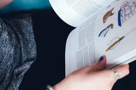 A person holding a book in his hand