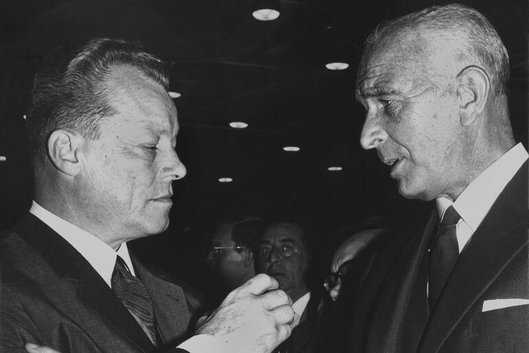 Berlin’s mayor at the time, Willy Brandt (left), and the director of the Frankfurt city zoo, Prof. Bernhard Grzimek (right), lead author talks at a reception of their publisher Kindler at Frankfurter Buchmesse 1966