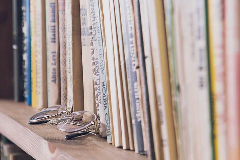 Reading glasses in front of a book wall