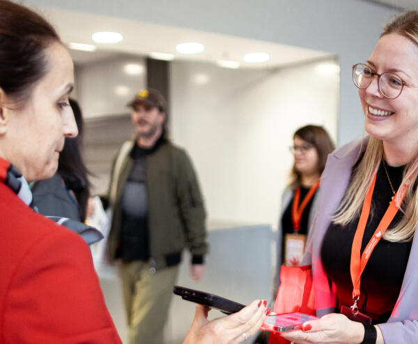 A woman happily shows her ticket at the entrance to the Frankfurter Buchmesse.