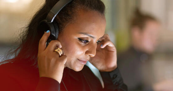 Woman listens to new audiobooks at Frankfurt Audio at Frankfurter Buchmesse 