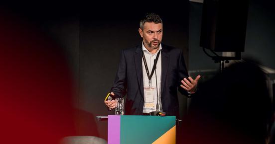 man talks on the business conference the markets stage