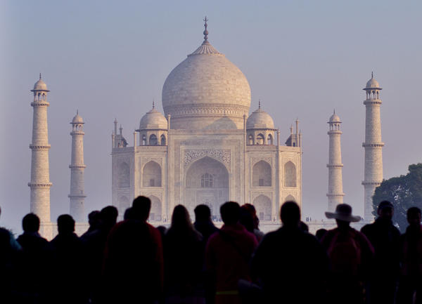 A crowd of people visiting the Taj Mahal.