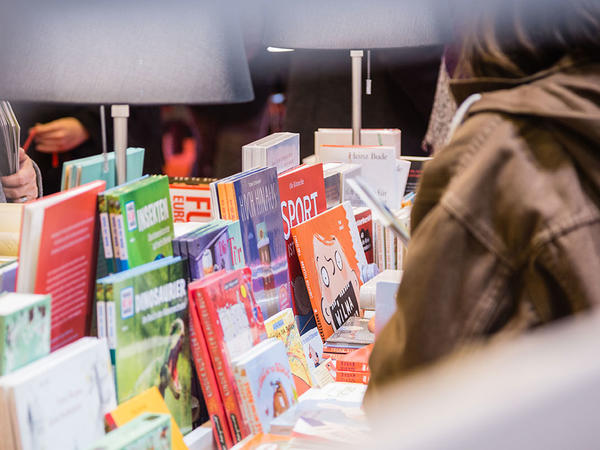 Woman searches through some books.