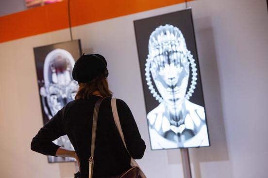 THE ARTS+ Woman looking at exhibition