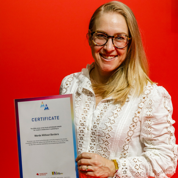 Elisabeth Jaquette poses with the winner's certificate for the 2026 Aficionado Award
