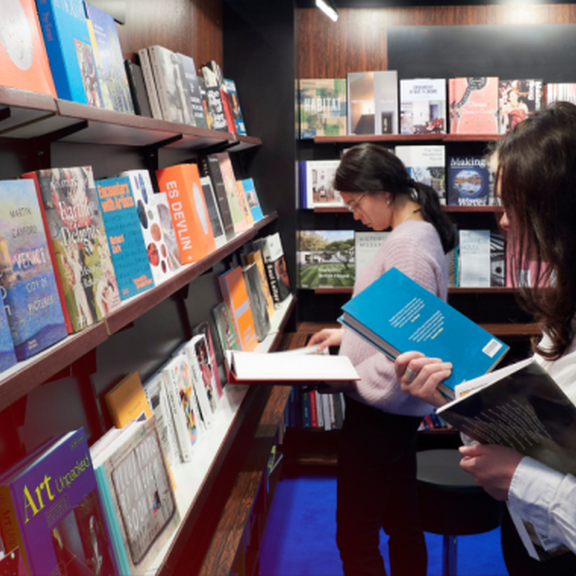Frau am Stand mit Buch