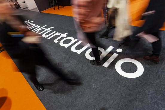 People walking across carpet with Frankfurt audio branding