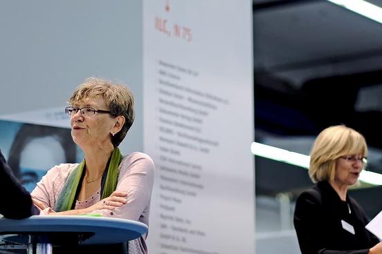 Two women having a chat on a stand-up table