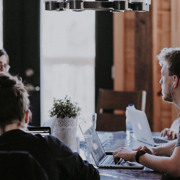 Group of people working on laptops
